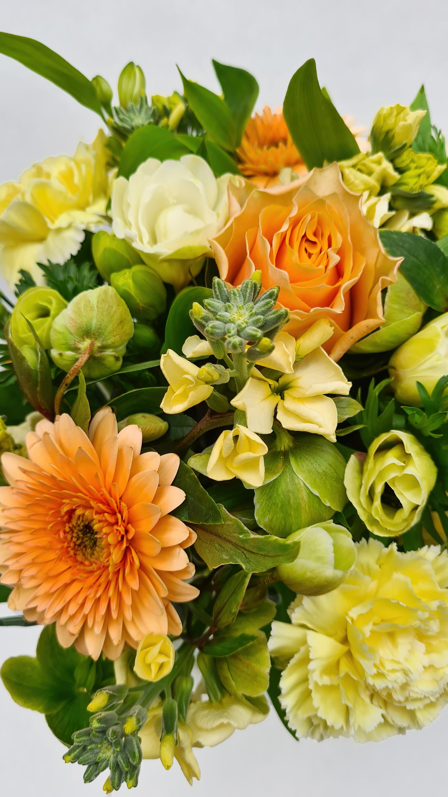 yellow green and orange bouquet up close