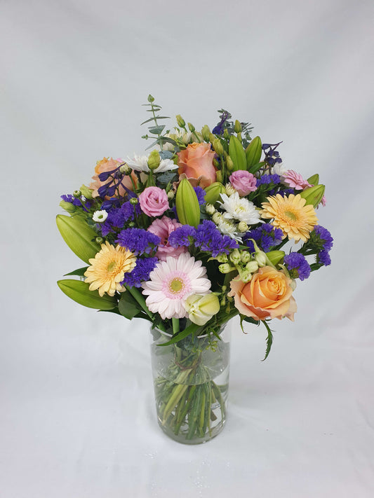 A colourful bouquet of pink, purple, green, orange, and yellow flowers.