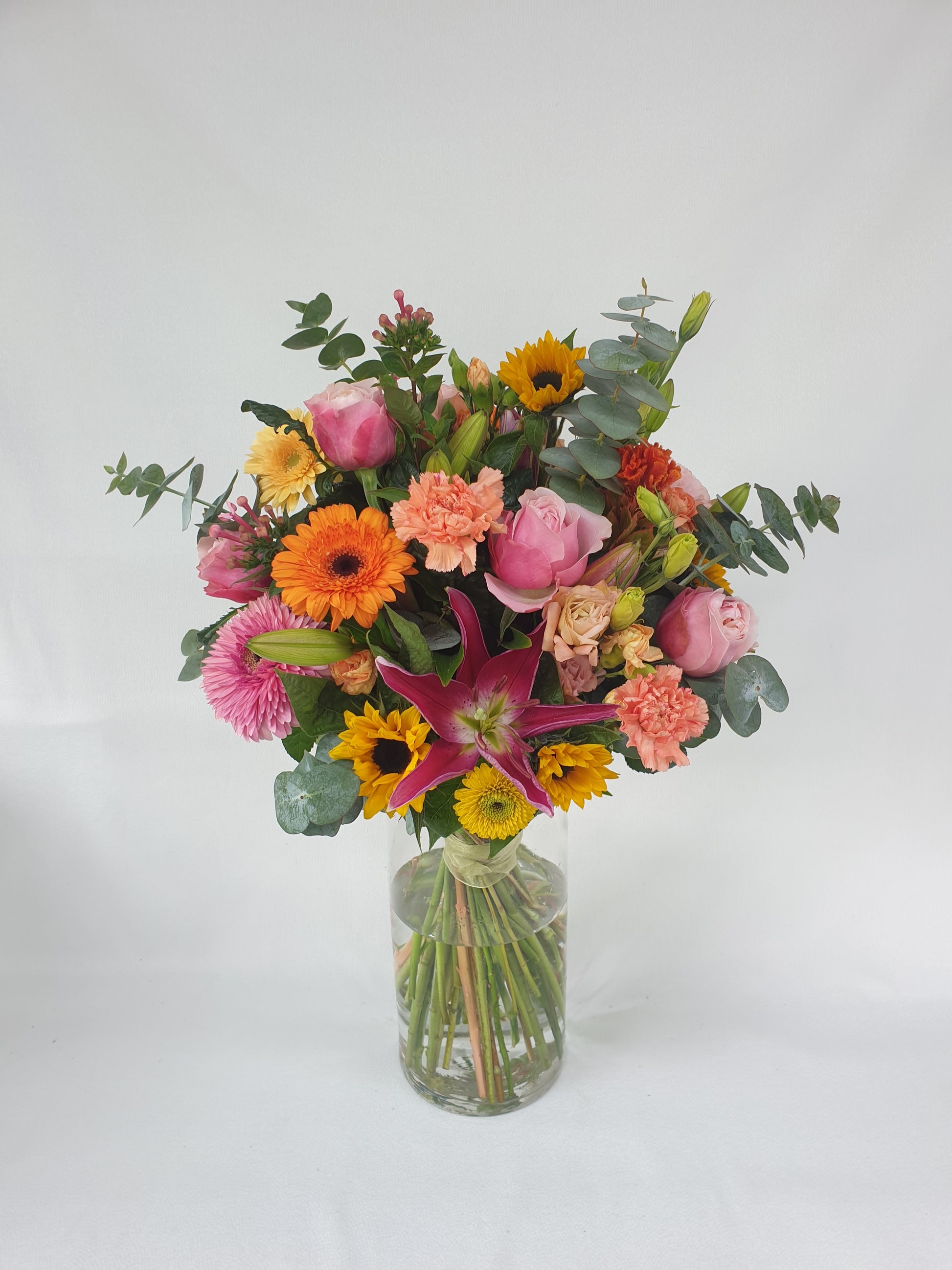 Orange, pink, and yellow bouquet showing what you can receive with our flower subscription.