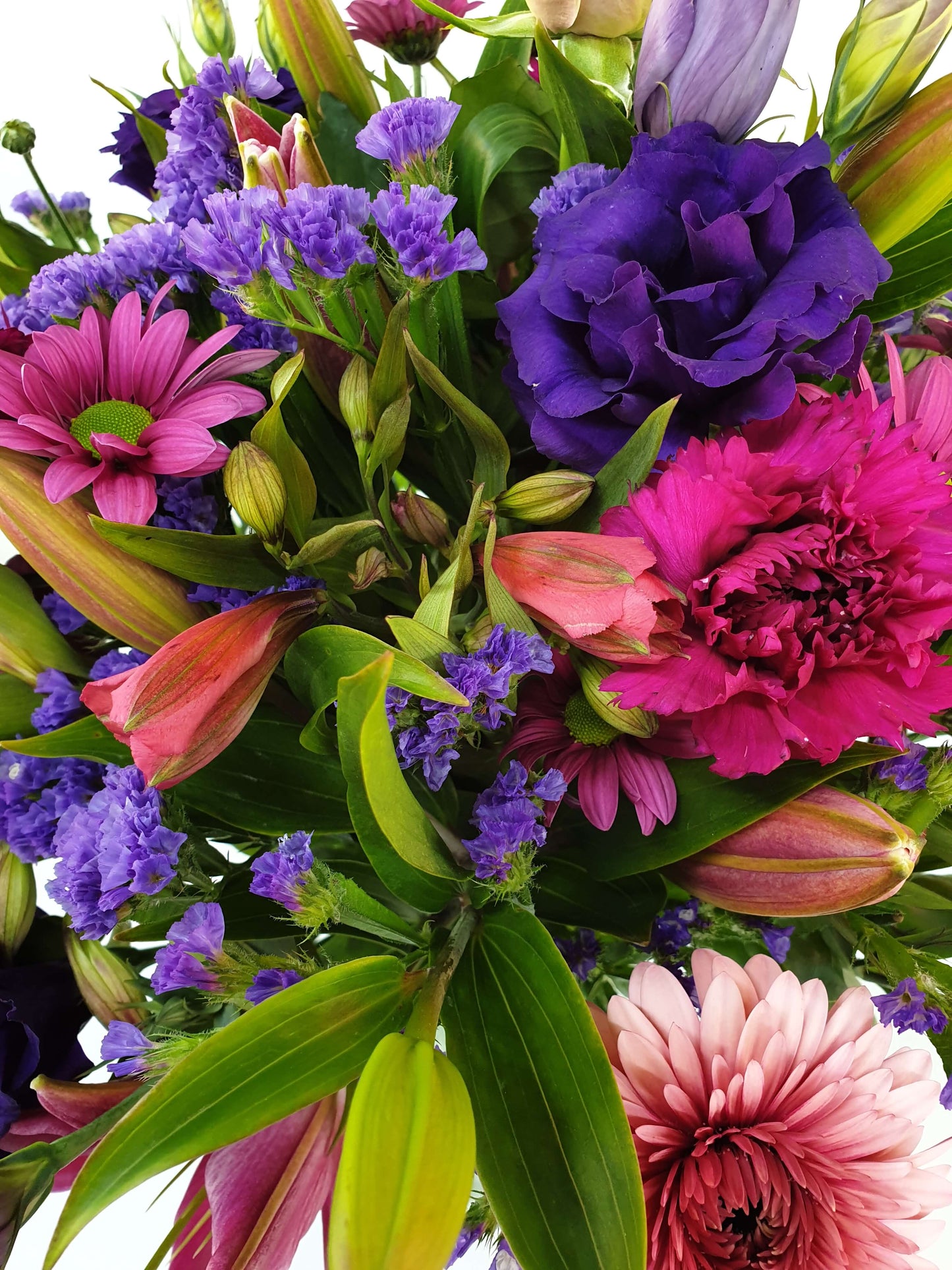pink and purple flowers in a bouquet up close