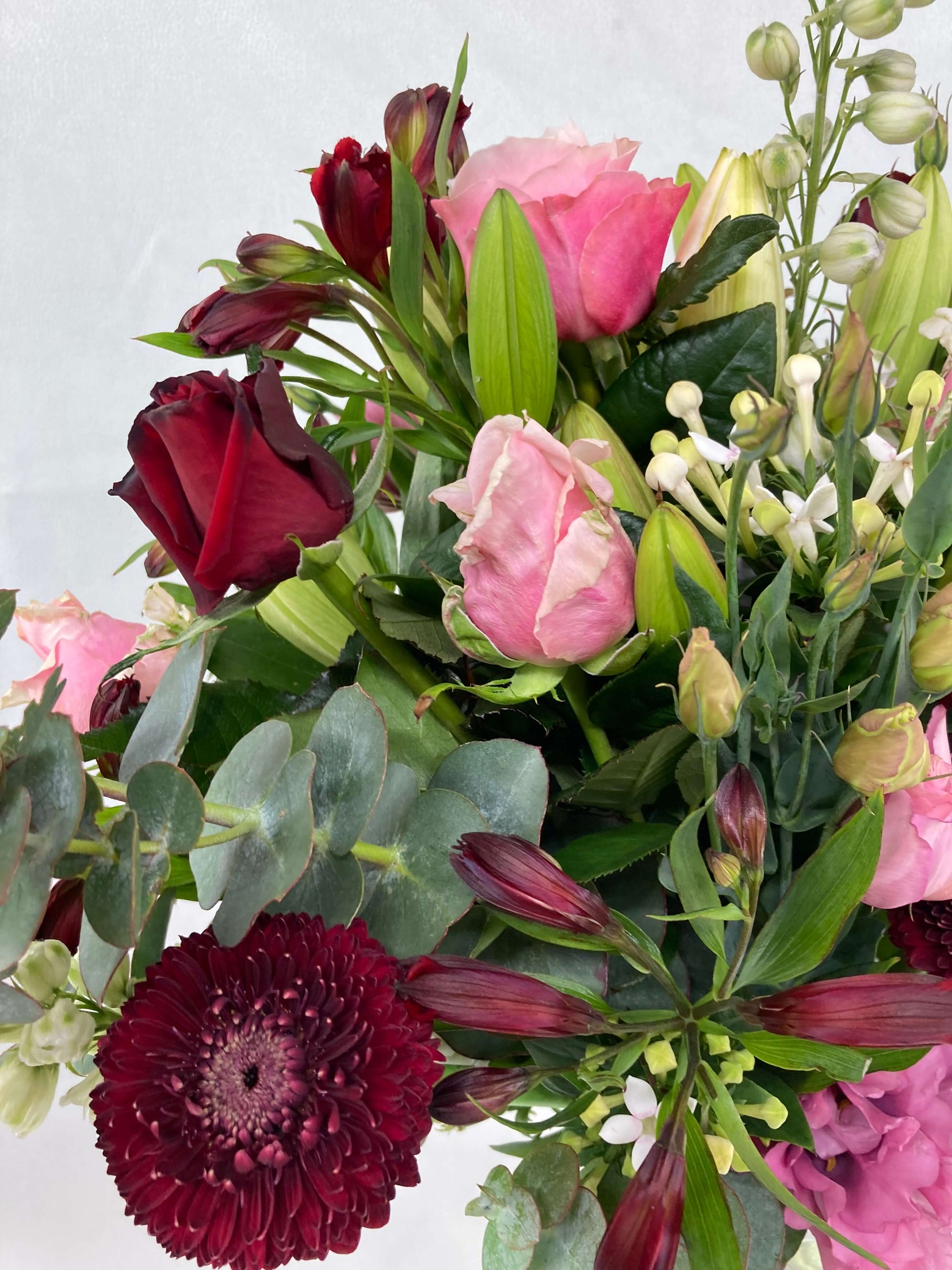 Our romantic bouquet up close. Full of pink and dark red flowers.