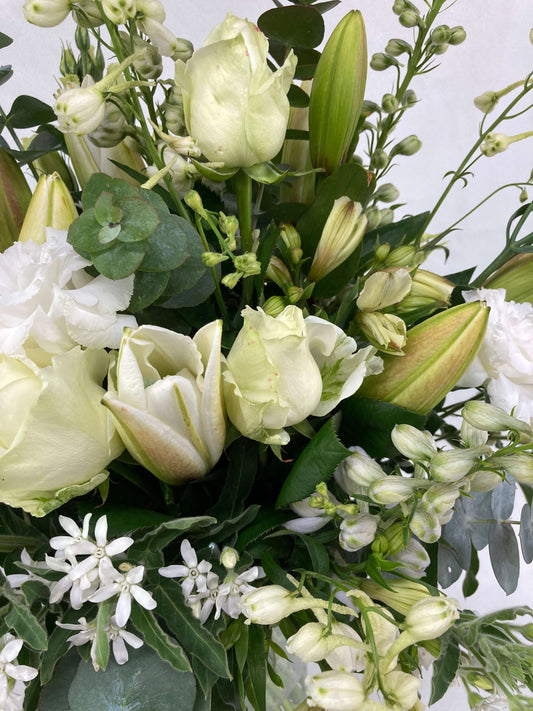 A white and green bouquet up close.
