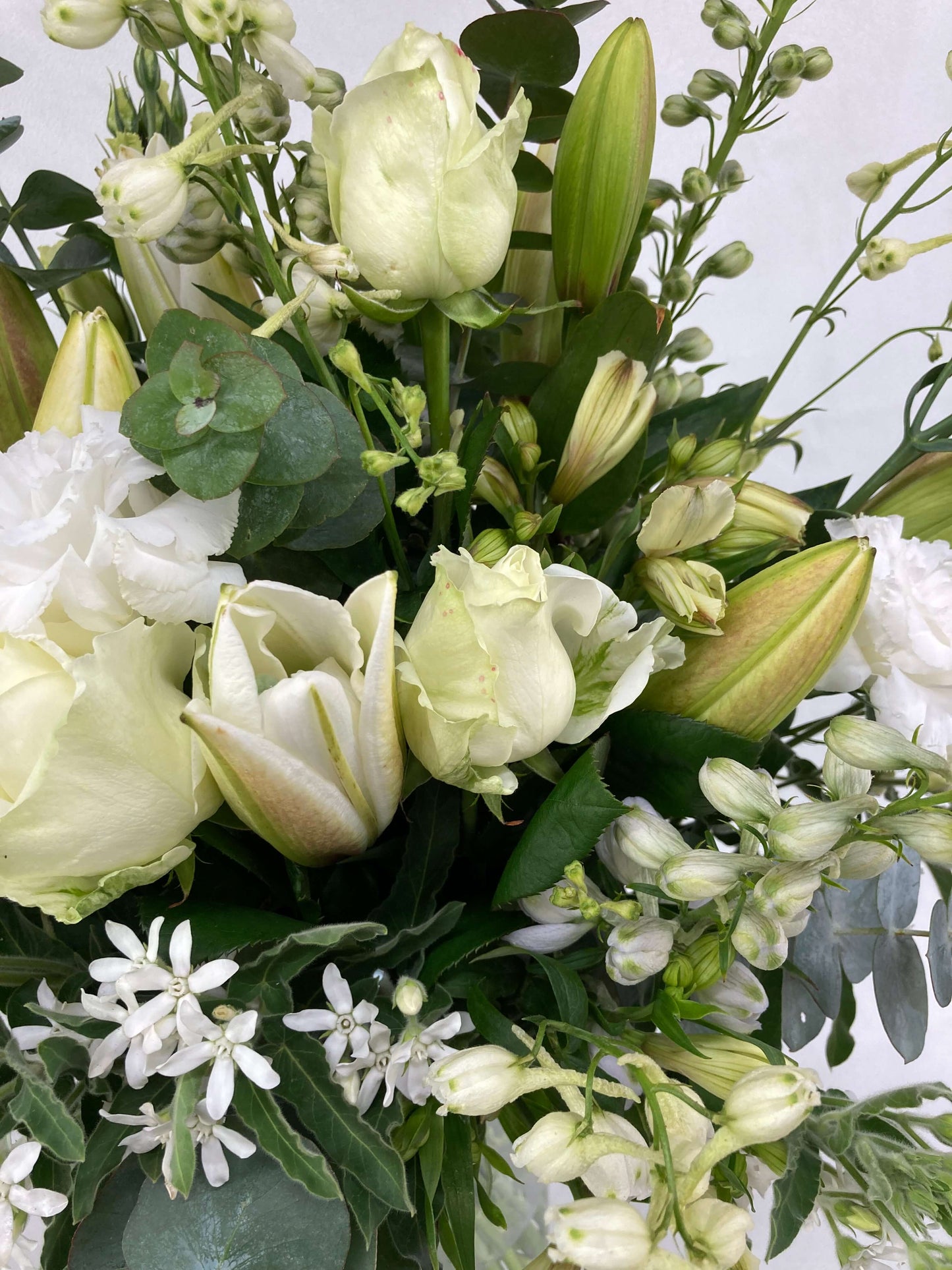 white and green flowers in bouquet up close