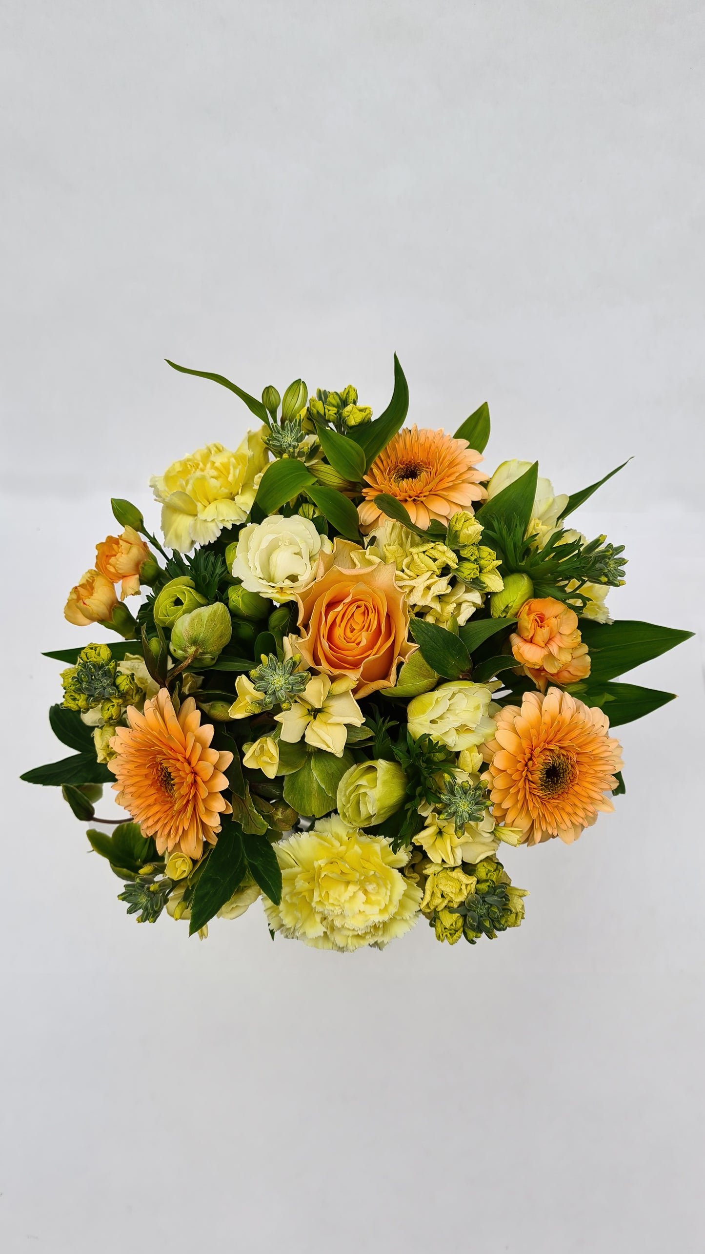 yellow, green, and orange flower arrangement from above