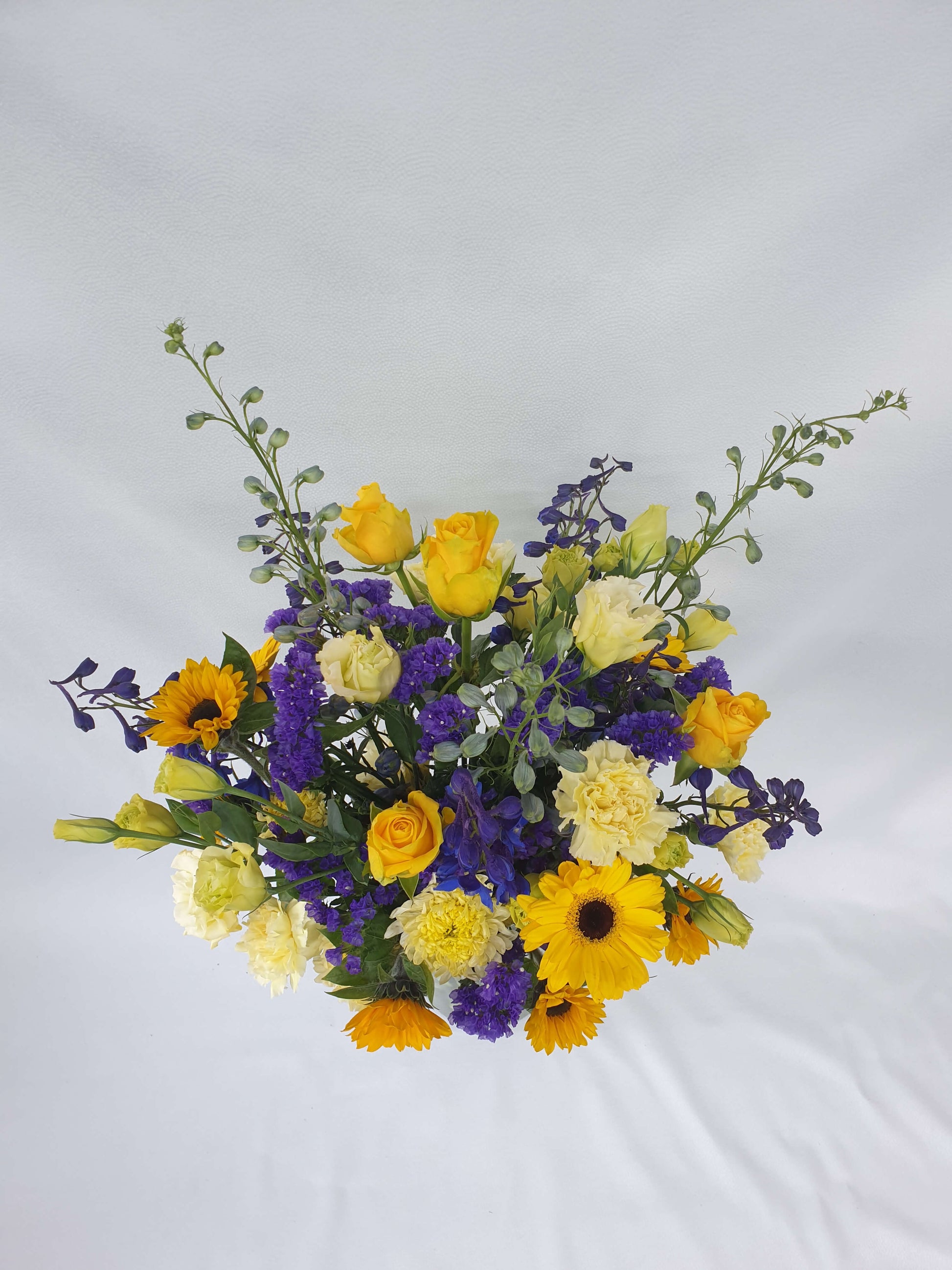 A blue and yellow bouquet from above.