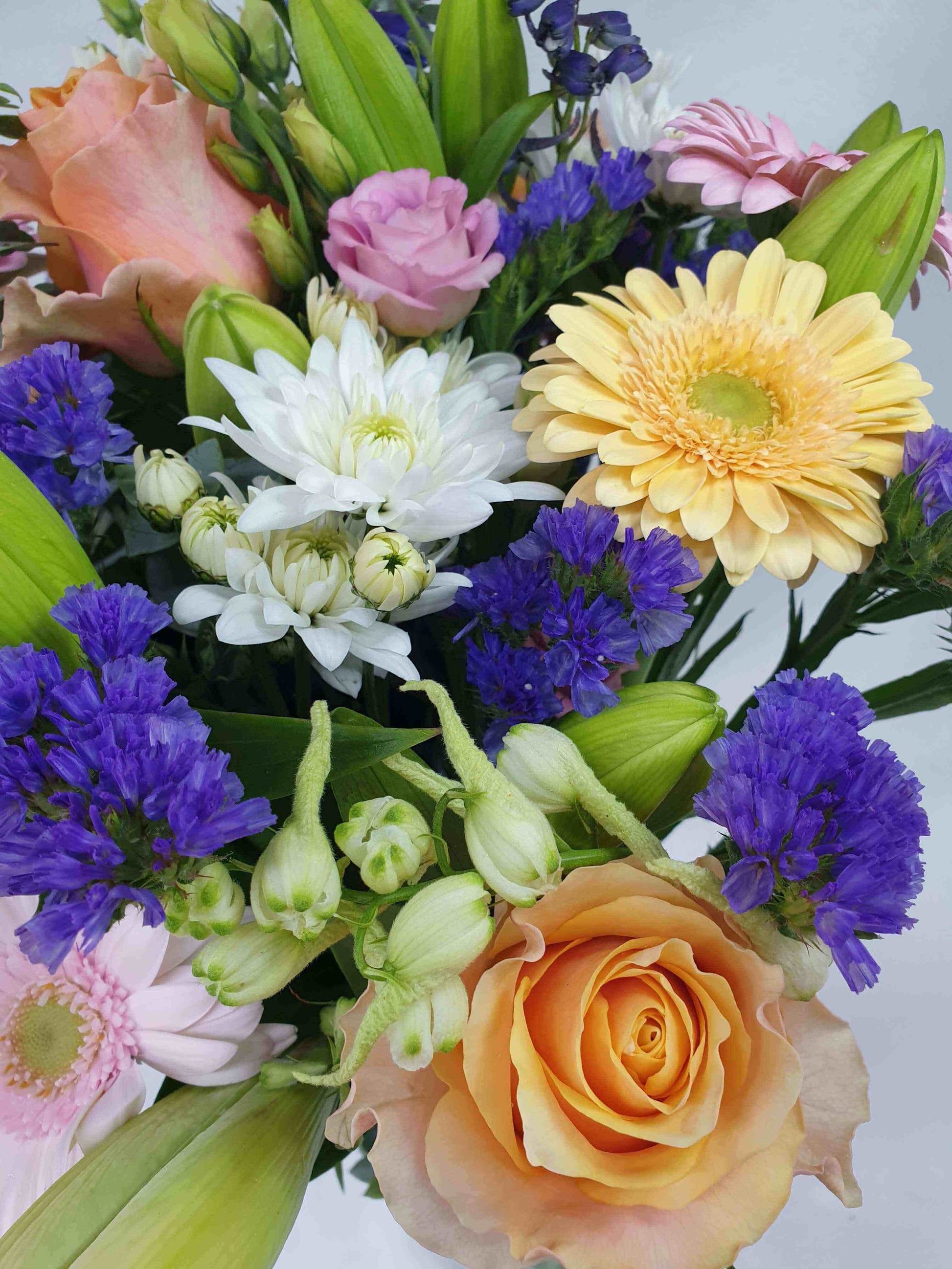 A close up of pink, purple, orange, yellow, white, and green flowers