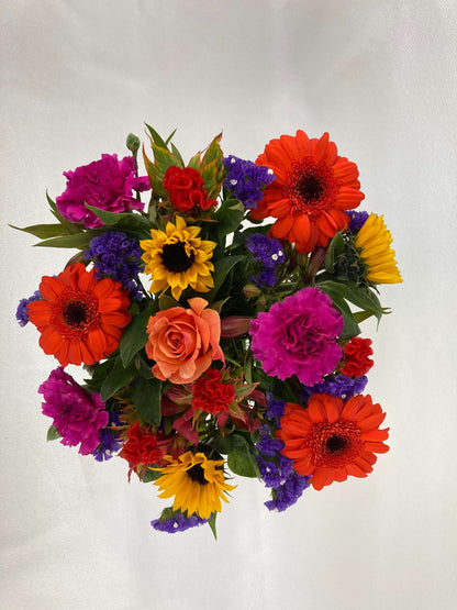 Bright posy consisting of orange, yellow, red, purple, and green flowers from above