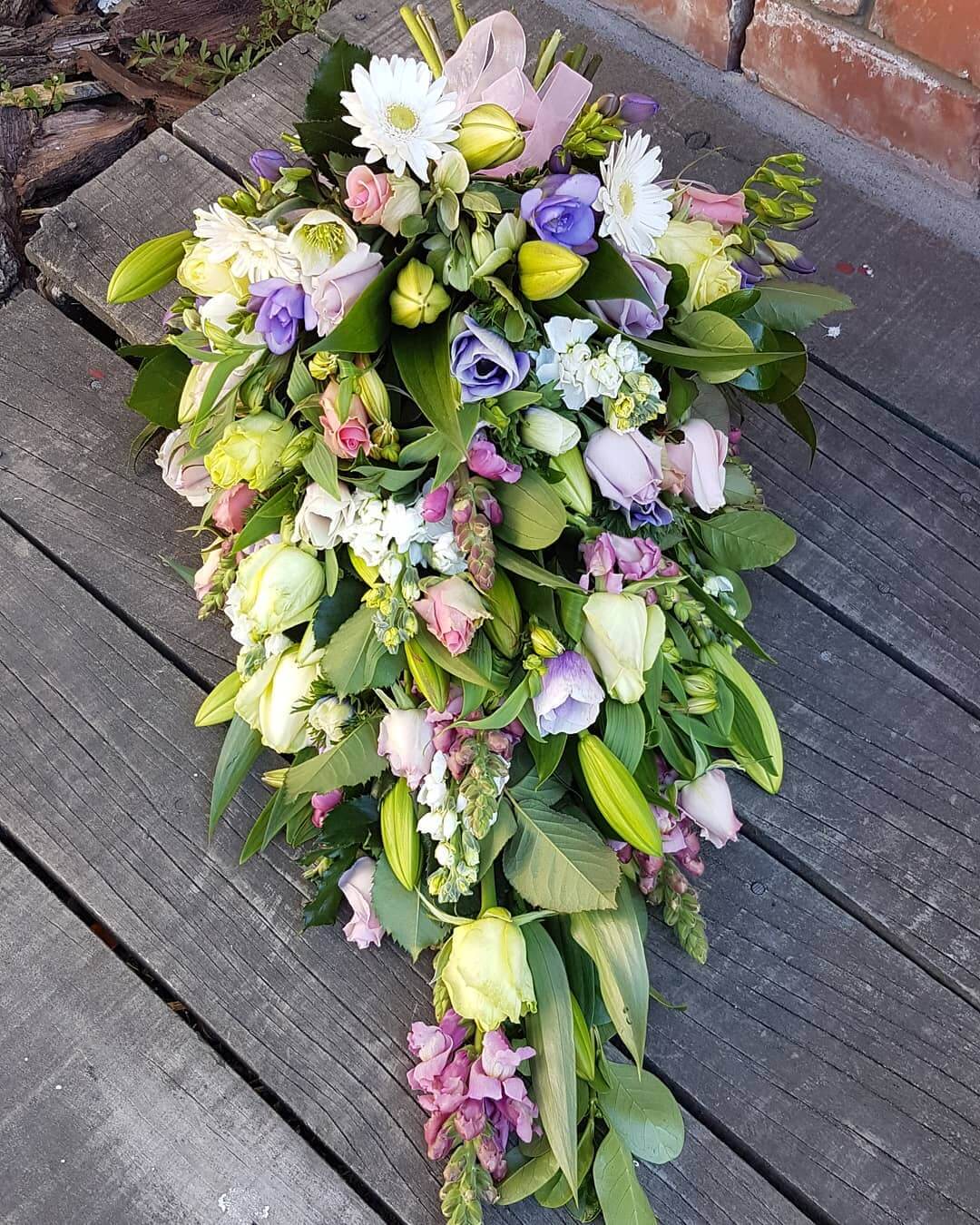 Pastel funeral flower sheaf arrangement
