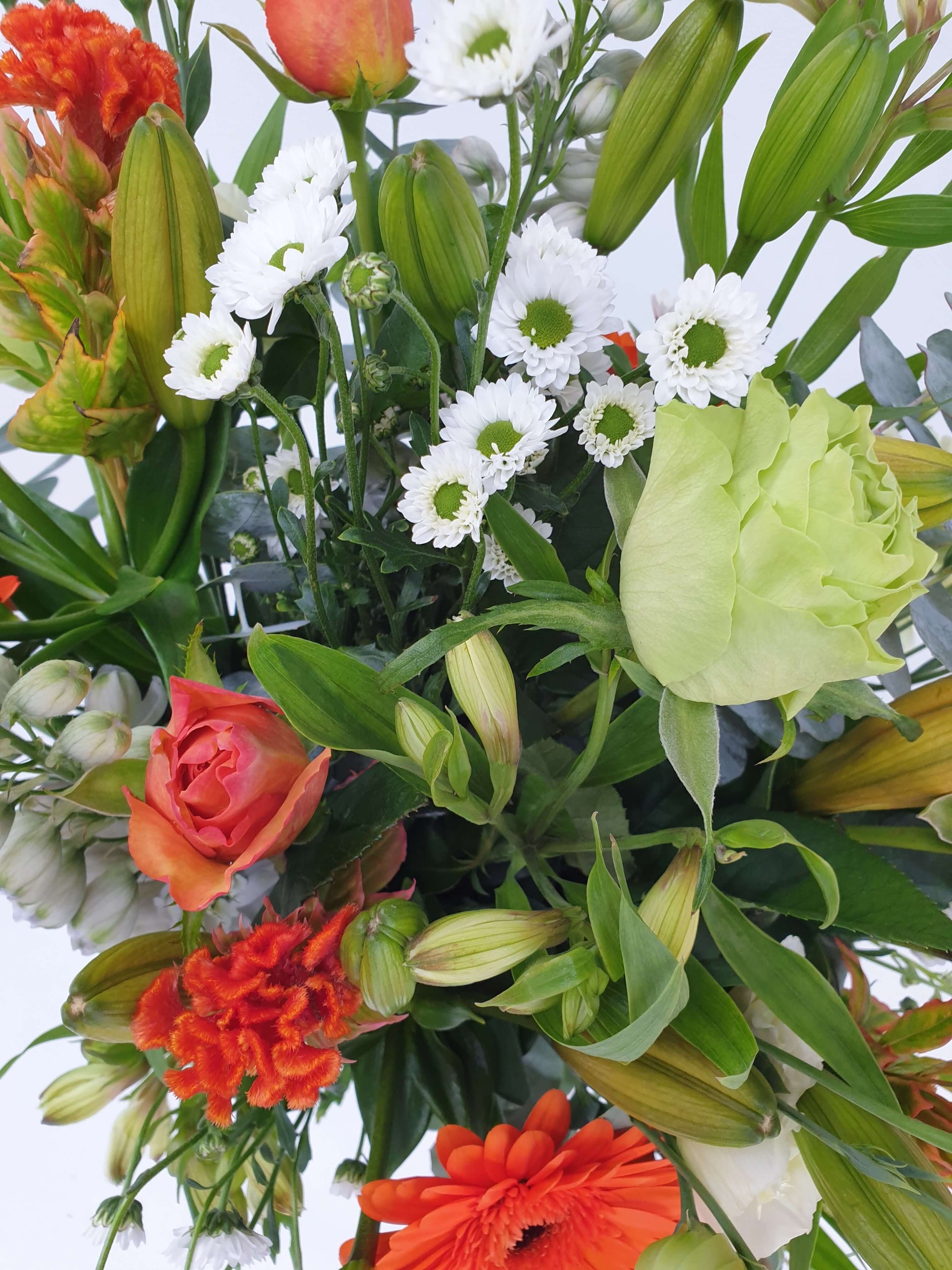 Orange white and green bouquet up close