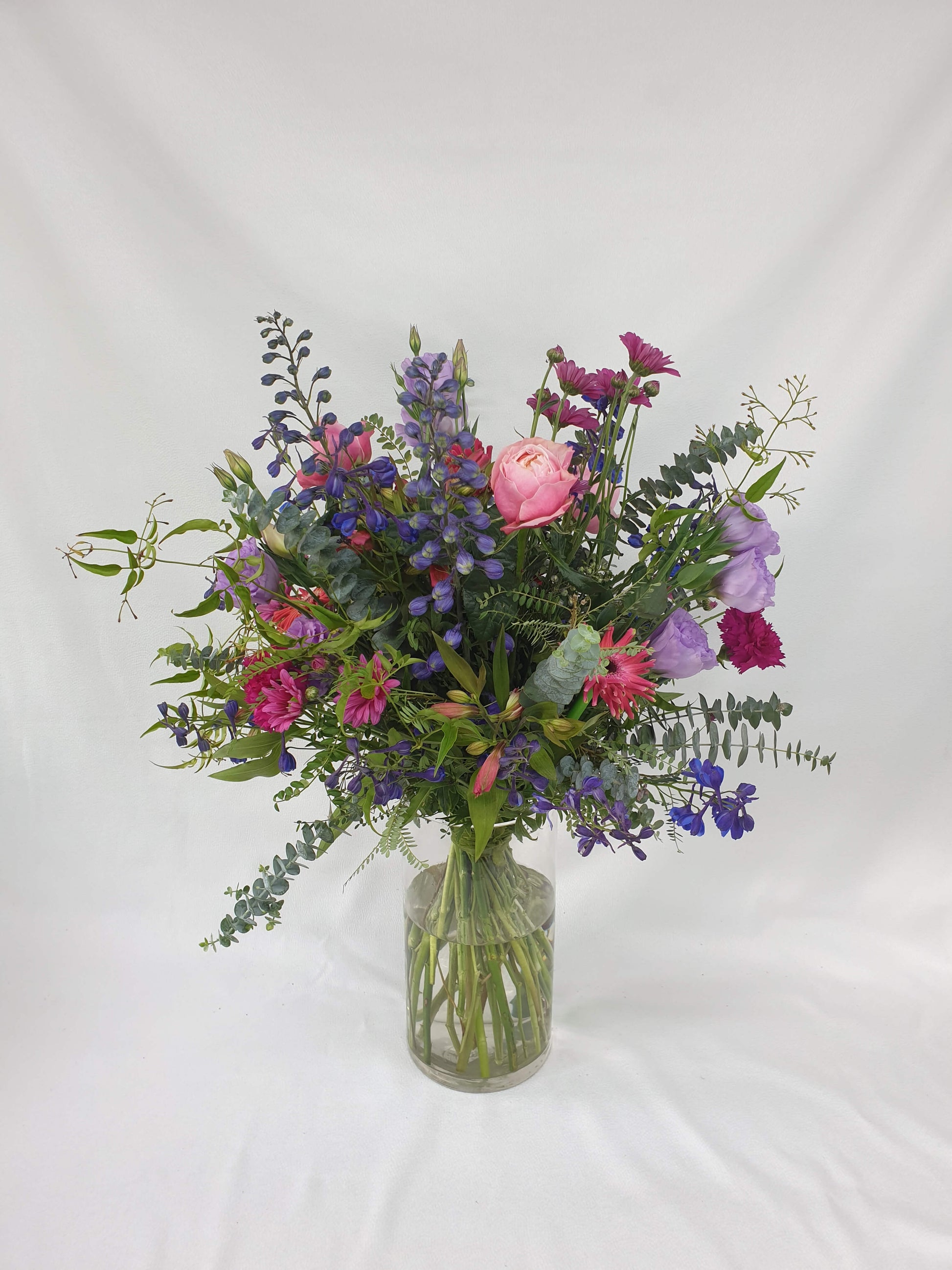 A pink and purple whimsical bouquet that you can receive from our flower subscription offer.