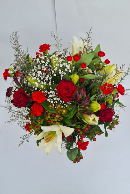 Bouquet of red and white flowers on a light gray background