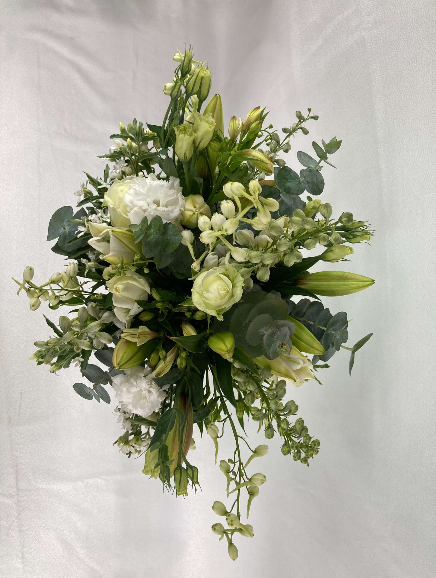 A white and green bouquet from above.