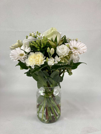 White and green short stemmed flowers. A posy.
